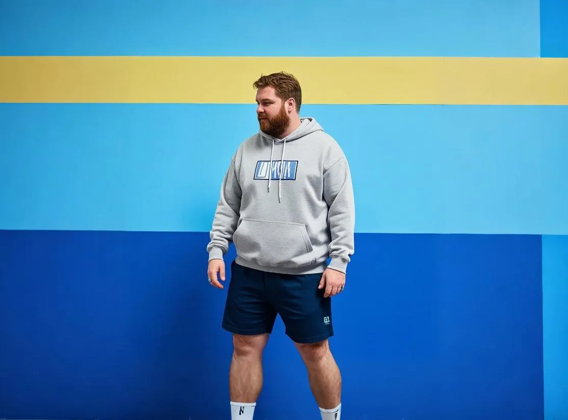 A man walks in big and tall athletic shorts.