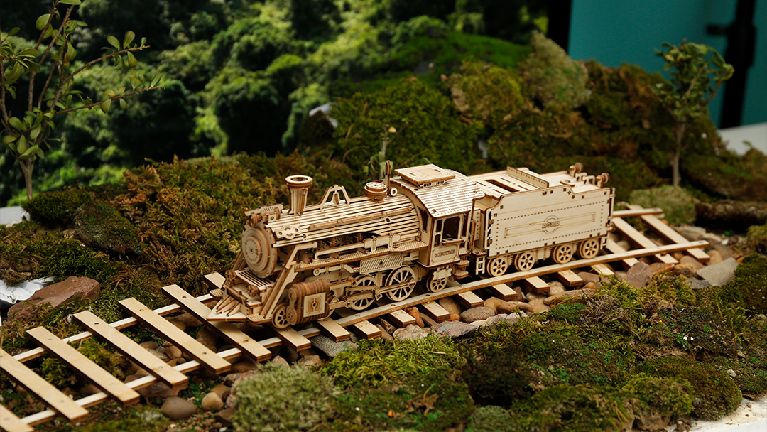 A model train is traveling on the tracks