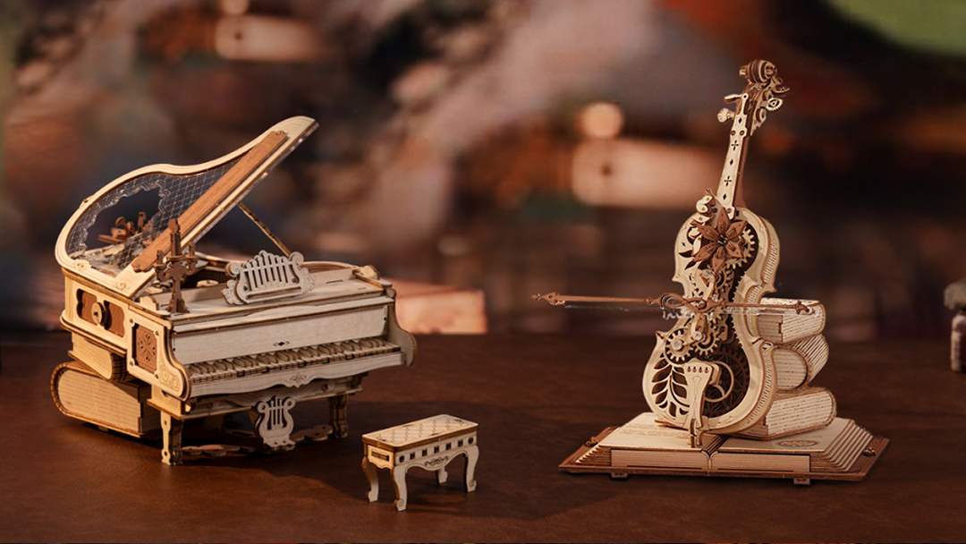 Two models of musical instruments are shown, including a cello and a piano.