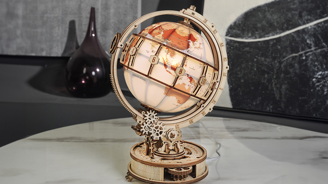 A model globe is displayed on a tabletop
