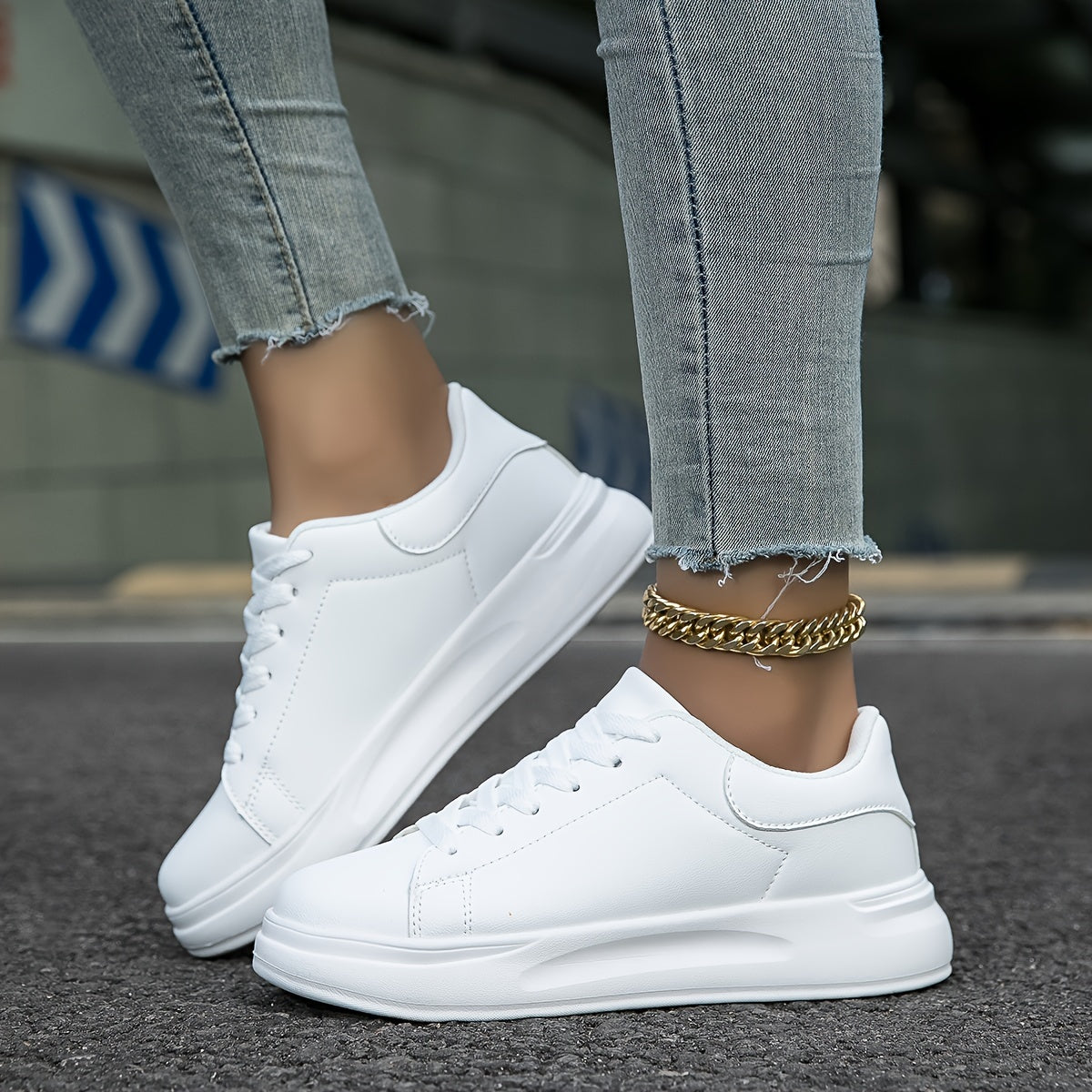 Woman wearing white leather sneakers