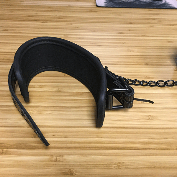 Black Hand Cuffs Shown On Desk In Detail