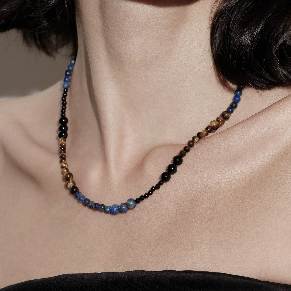 Elegant multicolor gemstone necklace featuring black onyx, tiger's eye, and lapis lazuli beads