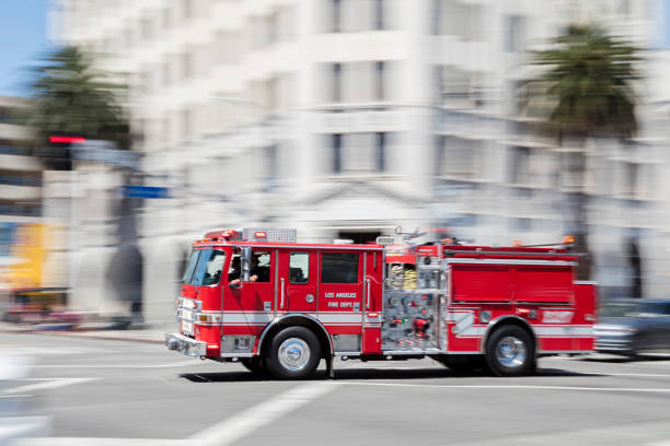 Fire Engine Rushing in Los Angeles Fire engine speeding in Los Angeles, motion blur. American Firefighter stock pictures, royalty-free photos & images
